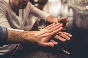 image of someone being stopped from picking car keys in a pub