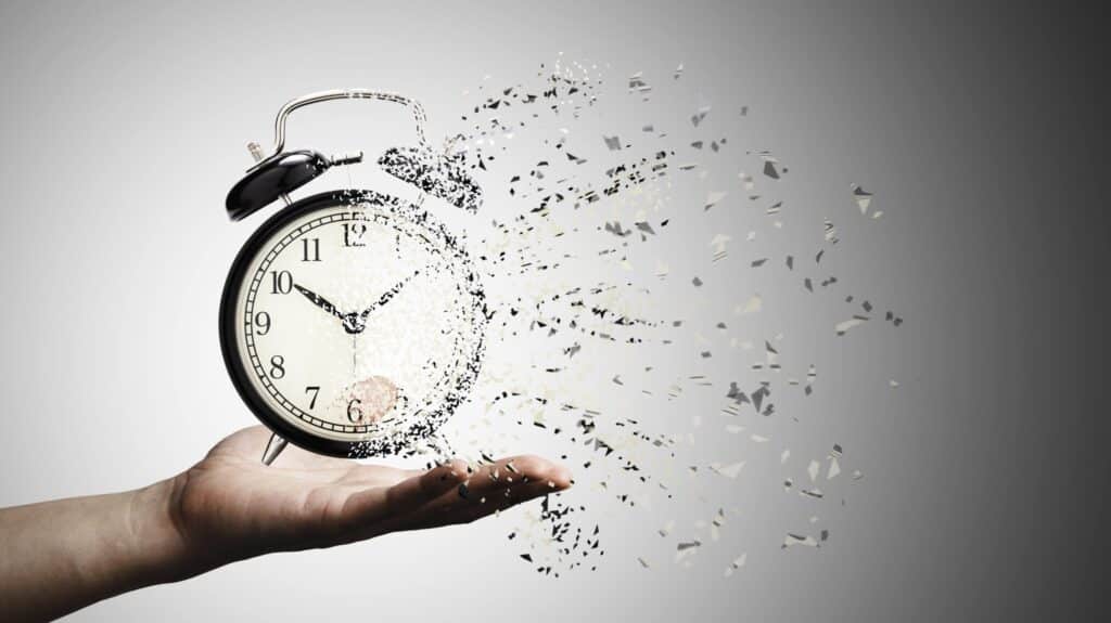 retro-black-alarm-clock-dissolving-into-little-particles-time-concept