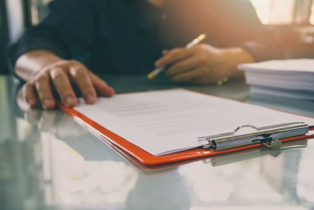 Close up of man about to sign a form