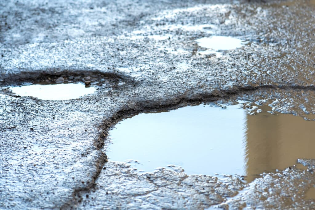 close-up-road-very-bad-condition-with-big-potholes