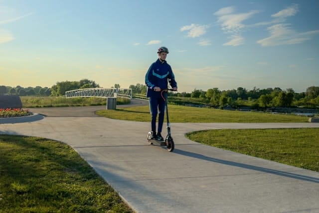 Man wearing a helmet riding an escooter