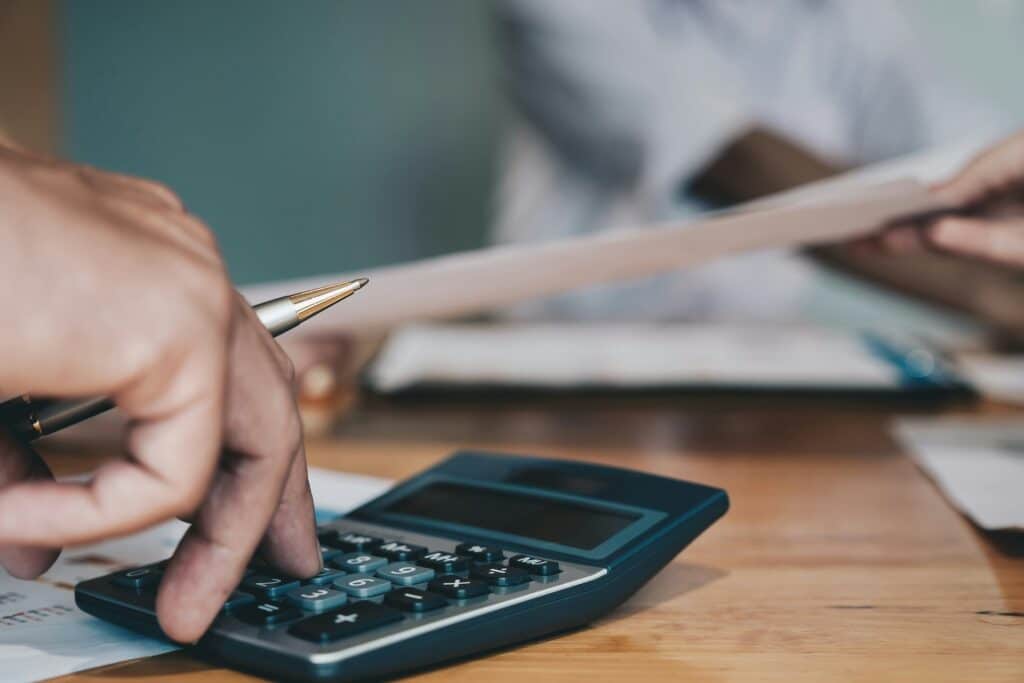 Zoomed in image of fingers on a calculator