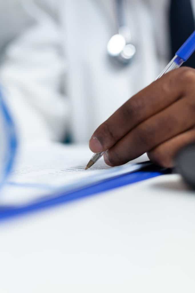 Closeup of a medical specialist doctor hand analyzing a document