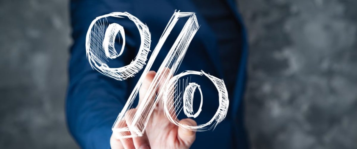 Young business man touching a percent sign on screen