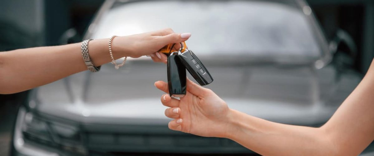 imge of someone handing car keys to another.
