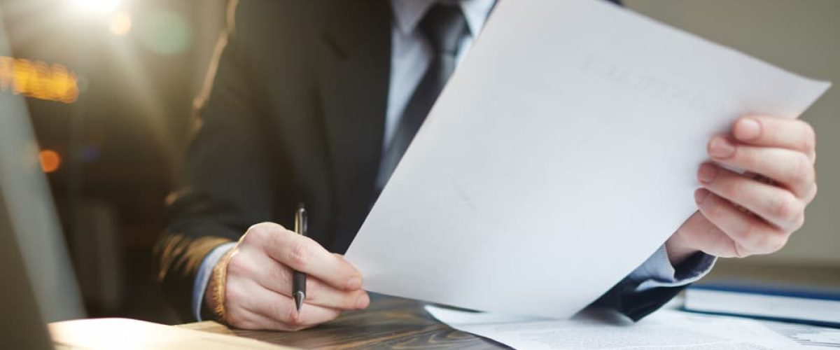 a man closely examining a document