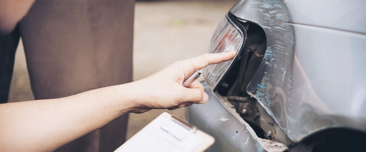 Insurance agent working during on site car accident claim process, people and car insurance claim