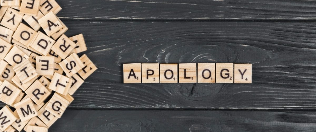 scrabble letter spelling apology