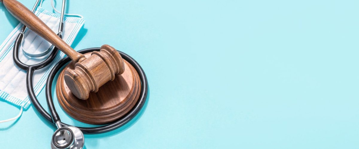 Judge gavel with medical mask and stethoscope on blue background Protection of medical rights concept