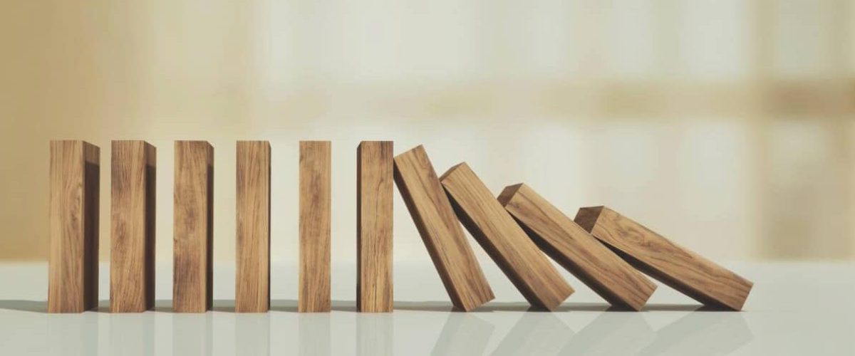 Wooden blocks paused from falling Risk management concept