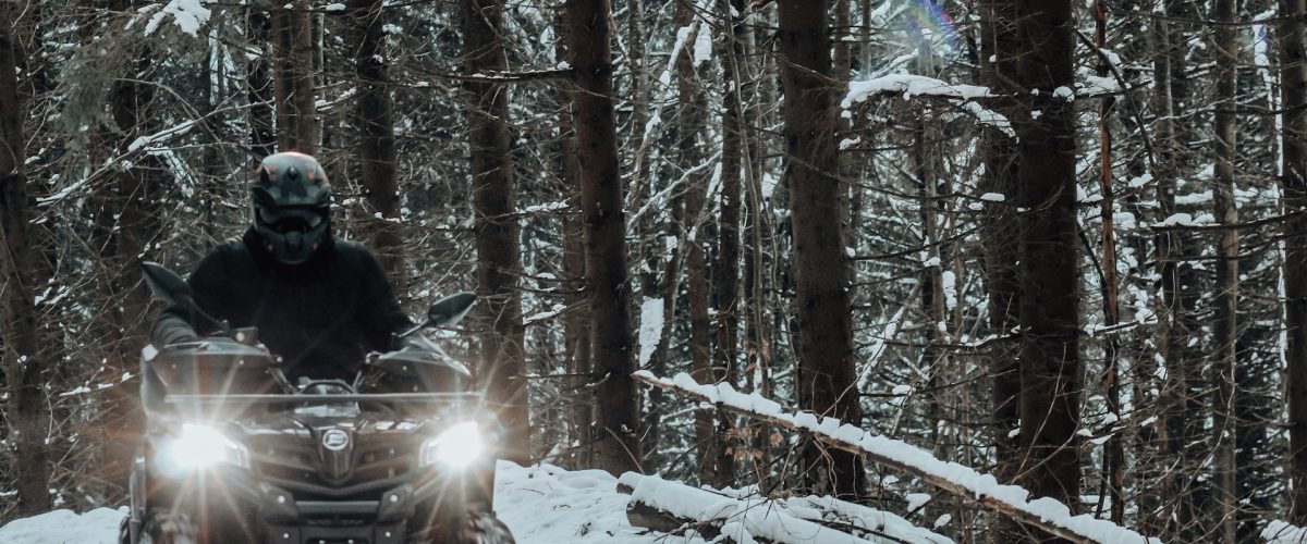 Man driving an ATV in snow