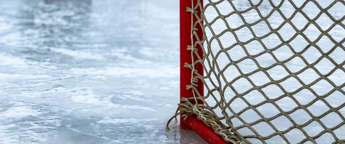 Image of edge of goal post in ice hockey ring