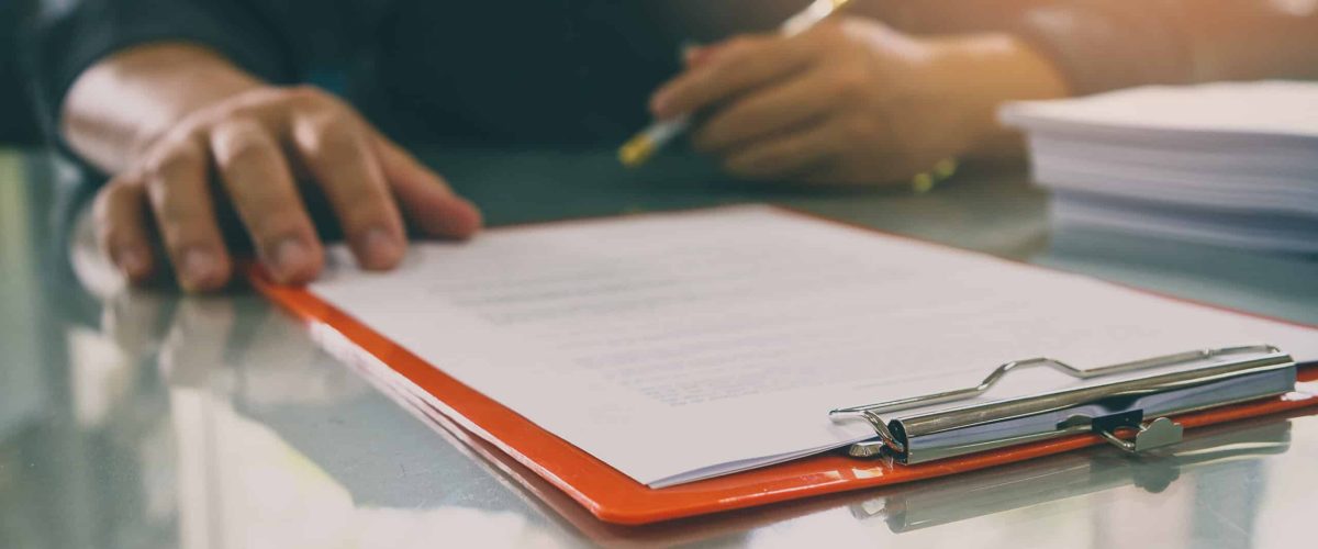 Close up of man about to sign a form
