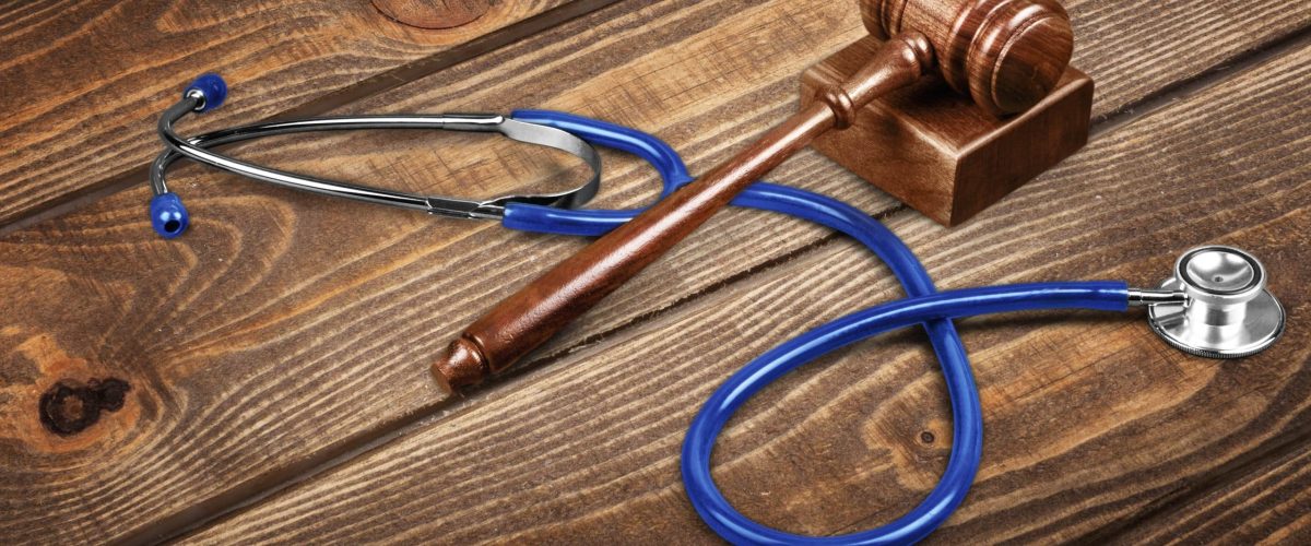 gavel-stethoscope-wooden-background-symbol-photo-bungling-medical-error