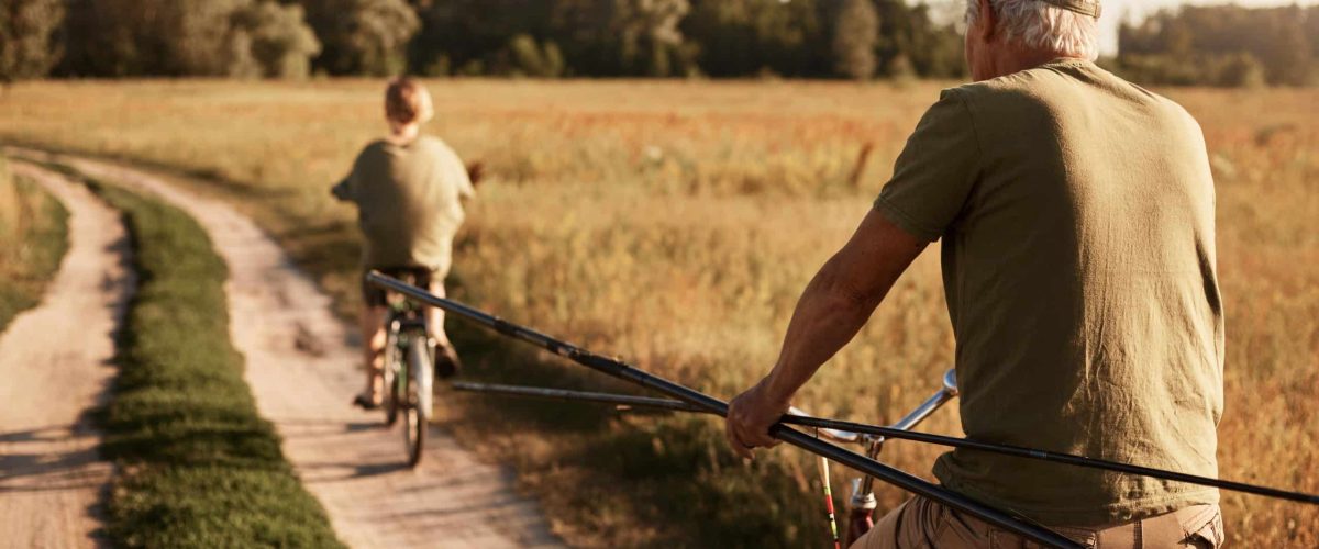 Image of retired man cycling with grand son