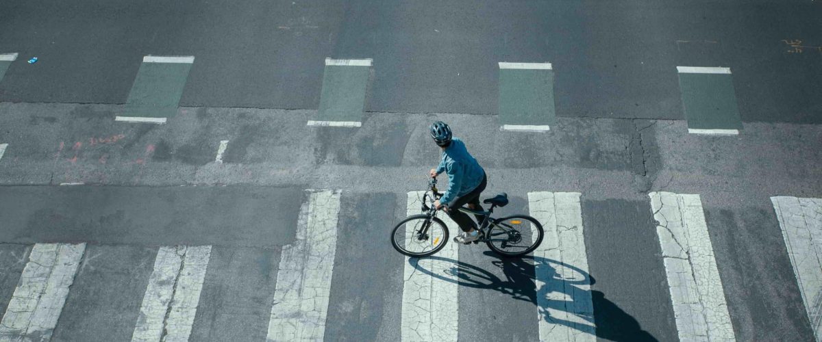 man riding an electric bike on a crosswalk