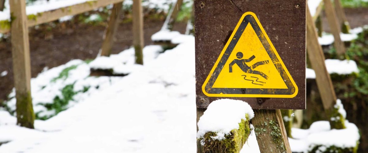 slippery-warning-sign-forest-wooden-bridge-covered-with-snow-winter-season-beware-danger-min
